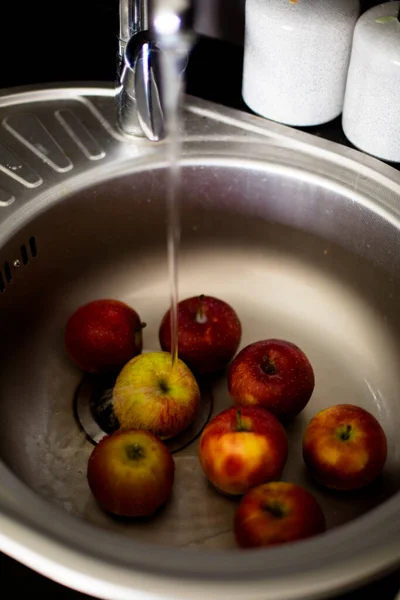 many apples at home near the sink lie on a towel and dried, wash with tap water fruits for hygiene, a cozy home style