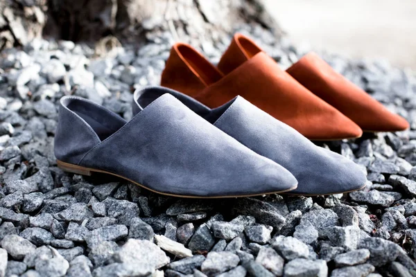 suede comfortable casual shoes outdoors on the grass in the park or in the forest, the sun shines on boxes with shoes