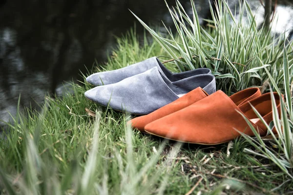 suede comfortable casual shoes outdoors on the grass in the park or in the forest, the sun shines on boxes with shoes