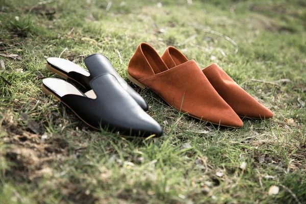 suede comfortable casual shoes outdoors on the grass in the park or in the forest, the sun shines on boxes with shoes