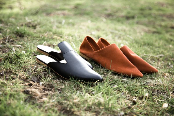 suede comfortable casual shoes outdoors on the grass in the park or in the forest, the sun shines on boxes with shoes