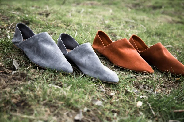 suede comfortable casual shoes outdoors on the grass in the park or in the forest, the sun shines on boxes with shoes