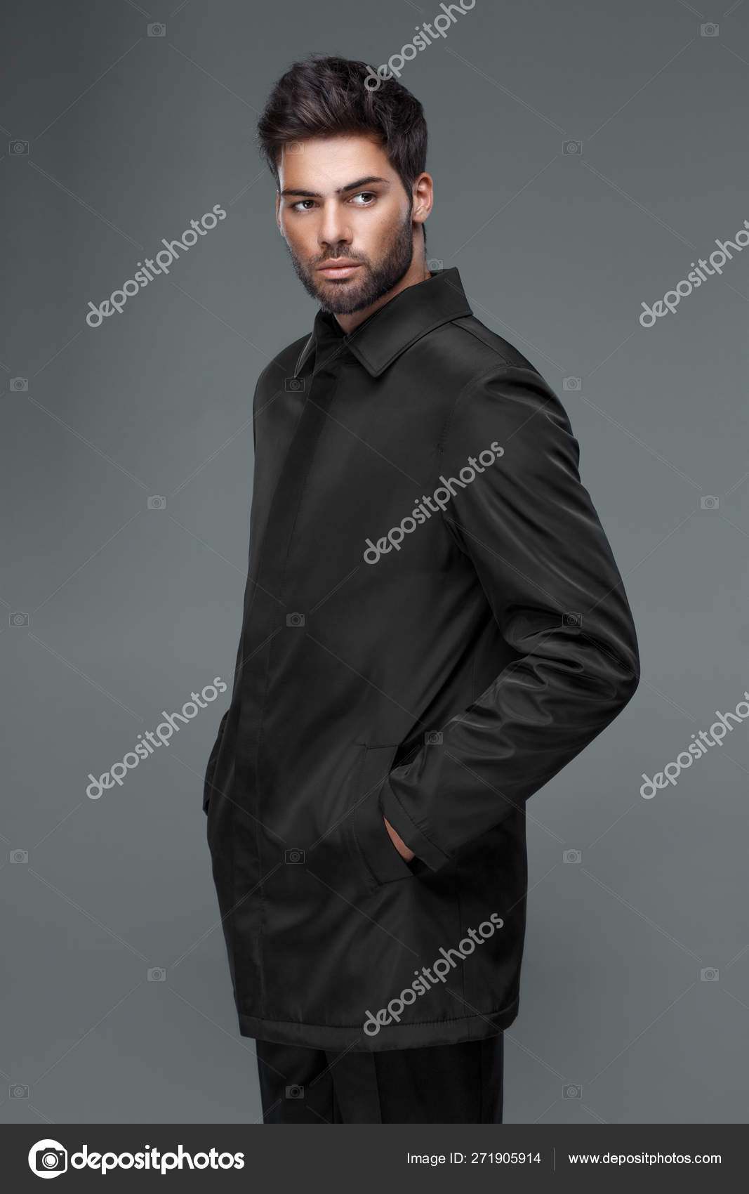 Handsome man with a trendy haircut in black coat, black shirt Stock