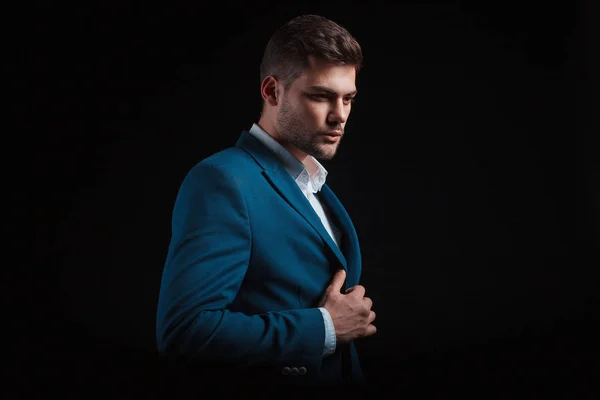 handsome man wearing suit posing on black background in studio