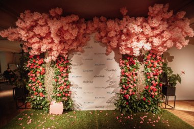 festive decorated arch with pink flowers clipart
