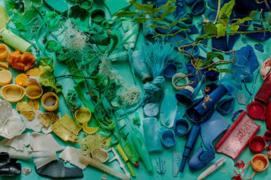 Rainbow made of colorful trash, waste recycling concept