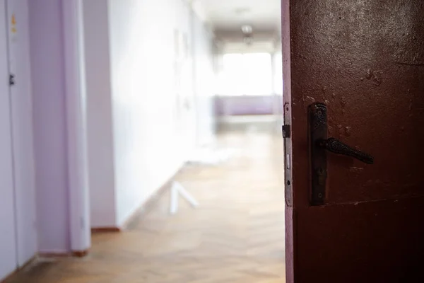 open dark door against light empty corridor of school. Ukrainian School during coronavirus quarantine. place for text. Copy space. school, education and learning concept,
