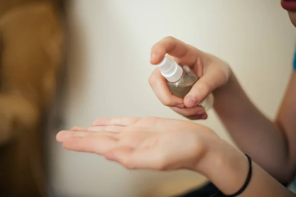 sanitizer in hands of child. Hand treatment is disinfection tool. Destroying viruses from surface of skin. Safety at risk of contracting coronavirus