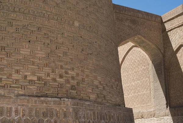 Old building with arch and passage. The ancient buildings of medieval Asia. Bukhara, Uzbekistan