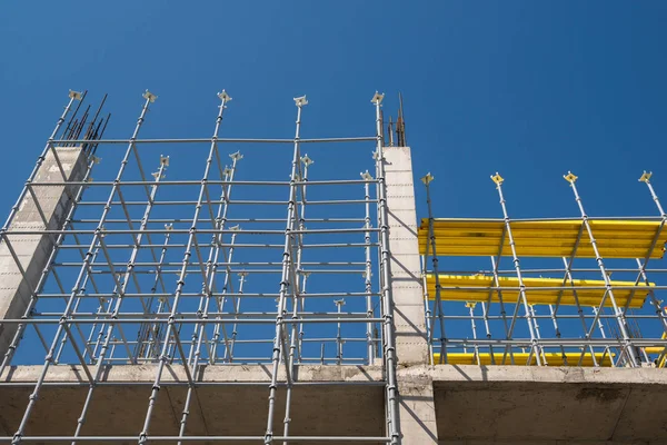 metal concrete structures of the building under construction. scaffolding and supports. bottom view