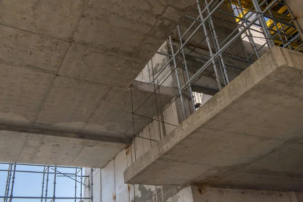 metal concrete structures of the building under construction. scaffolding and supports. bottom view