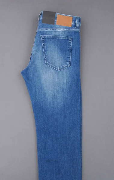 Fashionable Denim Pants Grey Background Top View — Stock Photo, Image
