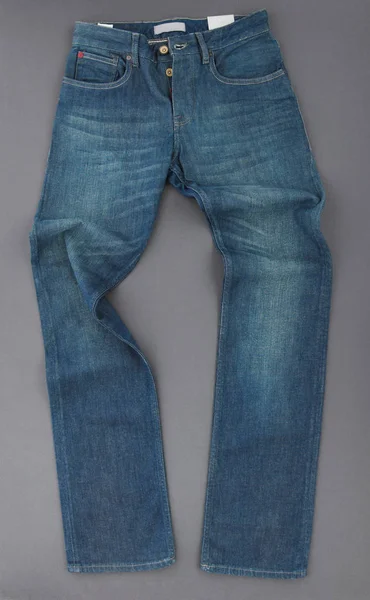 Fashionabla Denim Byxor Grå Bakgrund Ovanifrån — Stockfoto