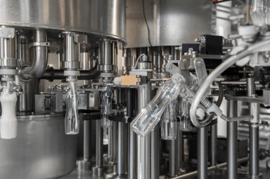Fabrikadaki plastik şişelere süt dolduruyor. Süt ürünleri fabrikasında.