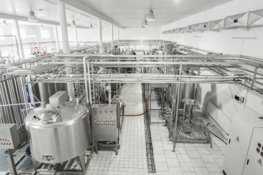 general view of the interior of a milk factory. equipment at the dairy plant clipart