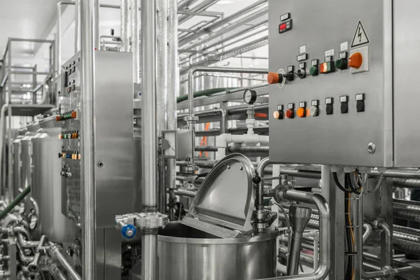 electronic control panel and tank at a milk factory. equipment at the dairy plant