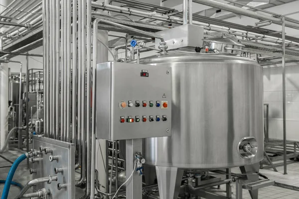 electronic control panel and tank at a milk factory. equipment at the dairy plant