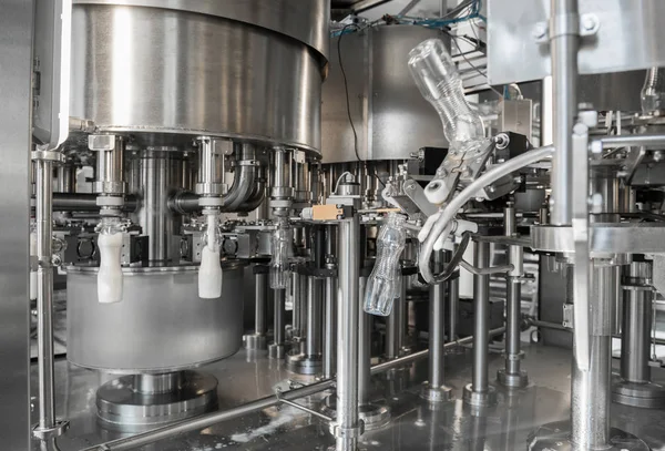 filling milk in to plastic bottles at the factory. equipment at the dairy plant