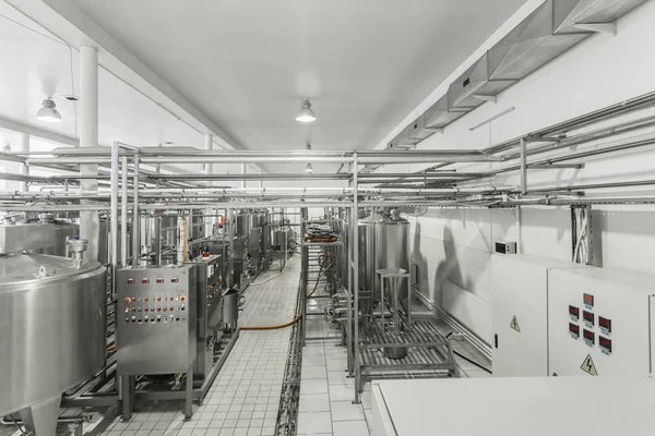 general view of the interior of a milk factory. equipment at the dairy plant