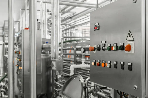 electronic control panel and tank at a milk factory. equipment at the dairy plant