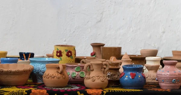 stock image lots of beautifully decorated clay pots. children's crafts