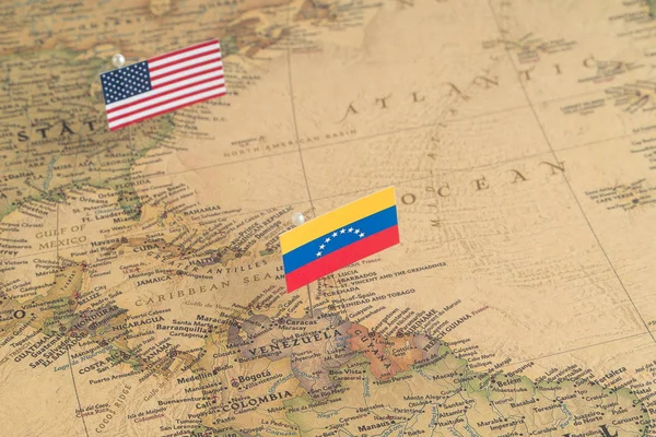 Flags of the USA and Venezuela on the world map. Conceptual photo, politics and world order