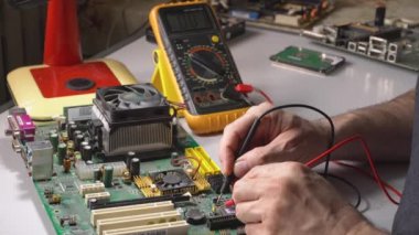 elektronik teknisyeni bir bilgisayar yongası test ediyor. Pc tamiri