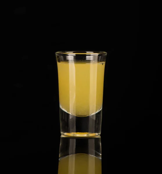 Shot glass with alcohol on a dark background — Stock Photo, Image