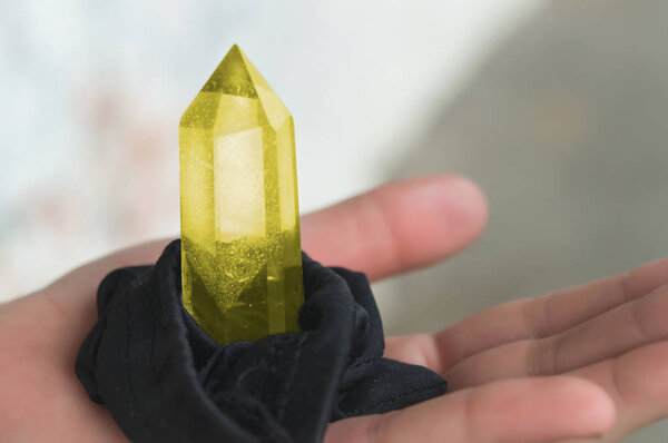 Large quartz crystal on a stump on a background of nature close-up.