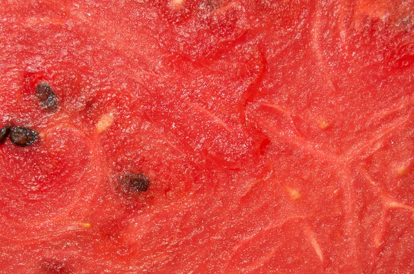 Uma textura saturada de vermelho suculento melancia fresca close-up — Fotografia de Stock