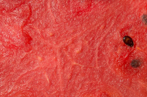Ένα κορεσμένο υφή του close-up κόκκινο ζουμερό καρπούζι φρέσκο — Φωτογραφία Αρχείου