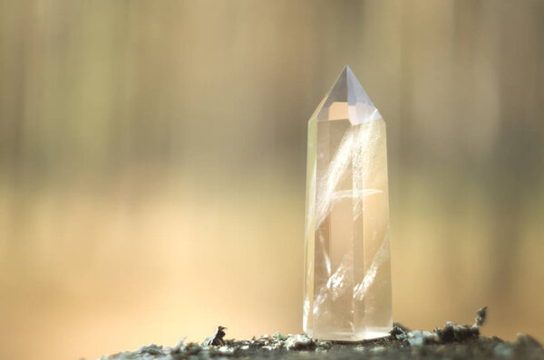 Large clear pure transparent great royal crystal of quartz chalcedony diamond brilliant on nature blurred bokeh background close up.