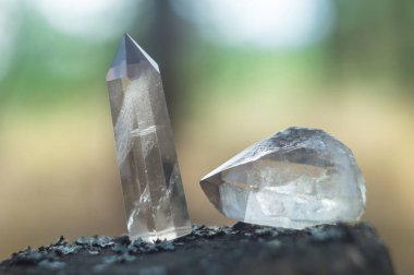 Large clear pure transparent great royal crystals of quartz chalcedony diamond brilliant on nature blurred bokeh background close up. clipart