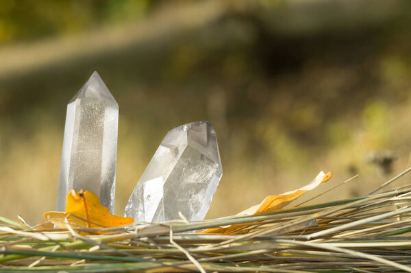 Large clear pure transparent great royal crystals of quartz chalcedony diamond brilliant on nature blurred bokeh autumn background close up