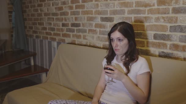 Young woman crying with wine in hands — Stock Video