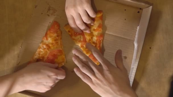 Gezelschap van drie mensen krijgt naar de laatste twee sneden pizza — Stockvideo