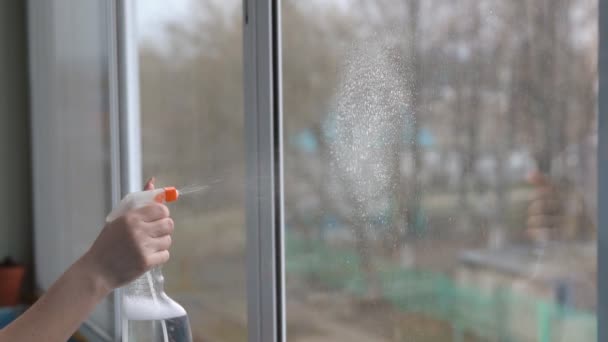 Young woman washing the window on the balcony — Stock Video