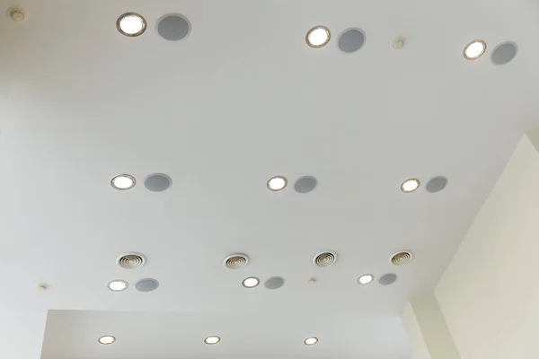 Suspended ceiling and plasterboard with built-in lights in the decoration of the apartment or house.