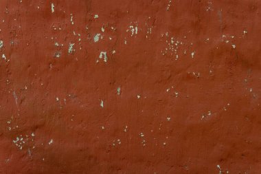 kırmızı duvar arka plan solmuş boya ile. Eski sıva doku.