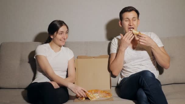 Jovem casal comer pizza — Vídeo de Stock