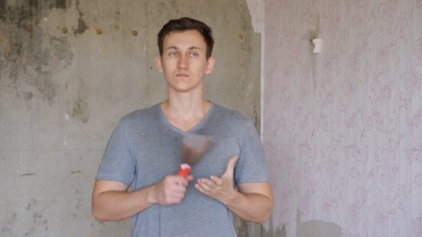 Man met pallet in de hand staan in kamer appartement — Stockvideo