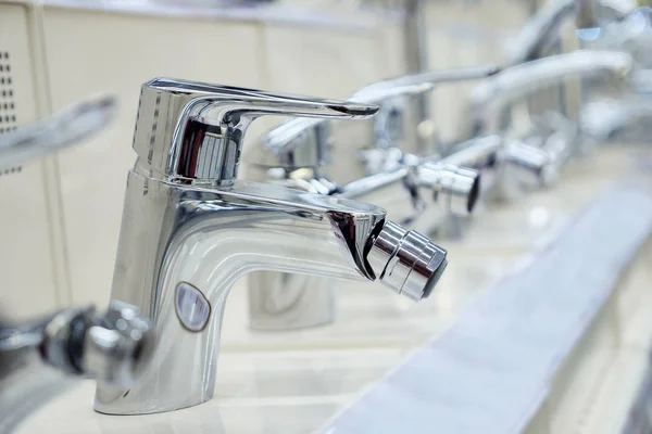 Water taps standing on shelf in shop — Stock Photo, Image