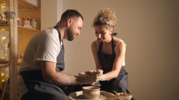 Happy couple making clay jug on potters wheel — Stock Video