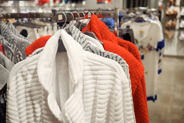 colorful sweaters for sale in modern clothes store