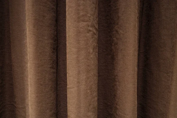 Dark brown curtains in folds