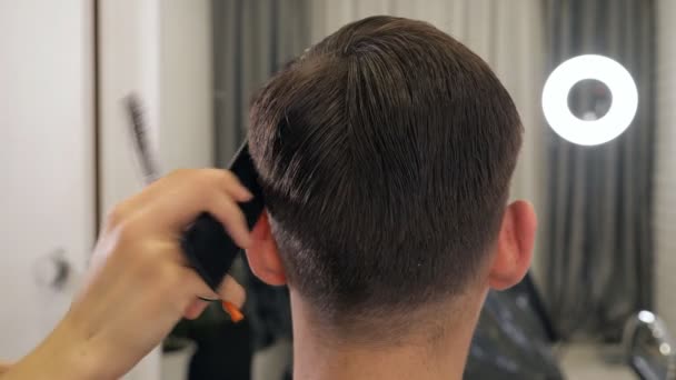 Close up of female hairdresser hairdressing male head — Stock Video