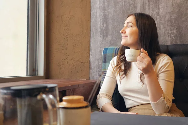 Unga skönhet romantiska kvinnan dricker varmt te eller kaffe på café — Stockfoto