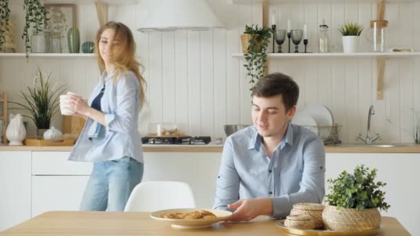 Dívka se podává snídaně, uvedení knedlíky na desku polibky chlap — Stock video