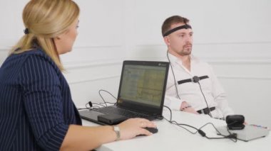Guy making a polygraph test.