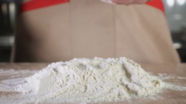 Baker is making a dough on the table. Hands close-up. — Stok video